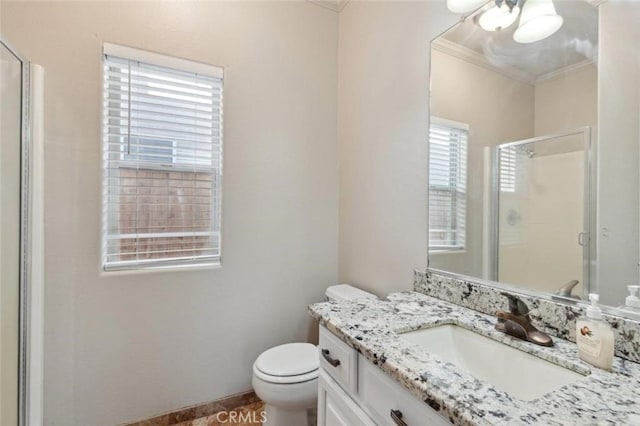 7538 N Erie Ave, Fresno, CA 93722 - full bathroom featuring ornamental molding, vanity, a stall shower, toilet, and ceiling fan