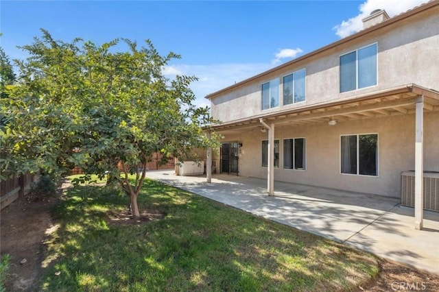7538 N Erie Ave, Fresno, CA 93722 - back of house featuring stucco siding, a patio area, and cooling unit