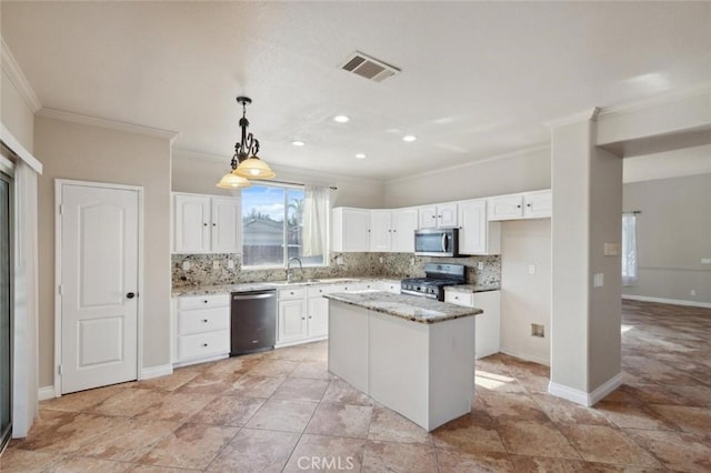 7538 N Erie Ave, Fresno, CA 93722 - kitchen featuring appliances with stainless steel finishes, ornamental molding, backsplash, white cabinets, and light stone countertops