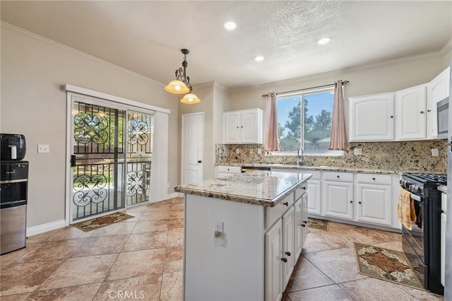 7538 N Erie Ave, Fresno, CA 93722 - kitchen with black range with gas cooktop, crown molding, light stone counters, healthy amount of natural light, and tasteful backsplash