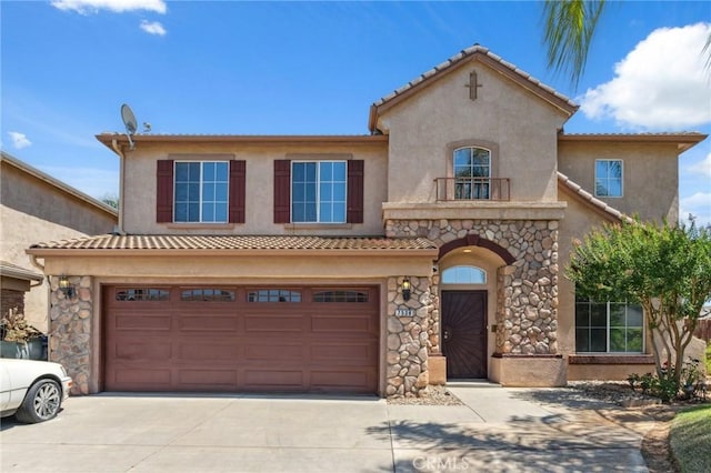7538 N Erie Ave, Fresno, CA 93722 - mediterranean / spanish-style home featuring concrete driveway, stucco siding, and a garage