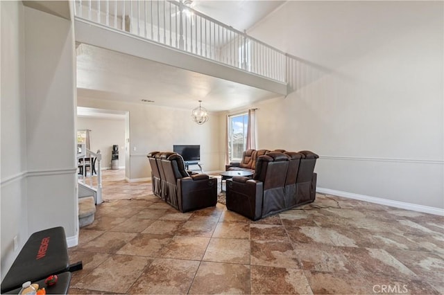 7538 N Erie Ave, Fresno, CA 93722 - living room with a high ceiling, a chandelier, and stone finish floors