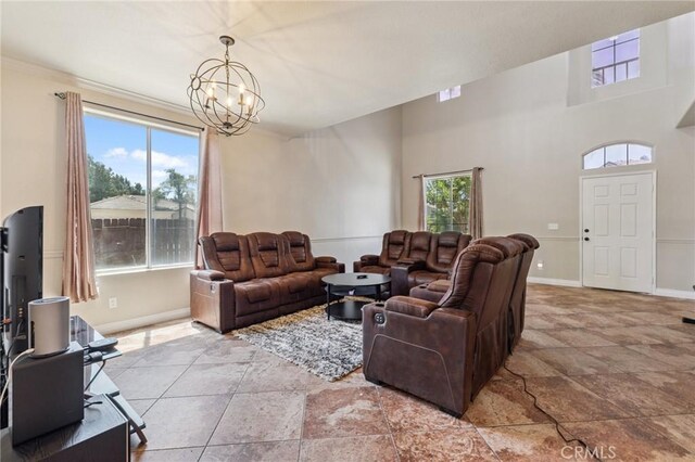 7538 N Erie Ave, Fresno, CA 93722 - living room with stone tile flooring and a chandelier