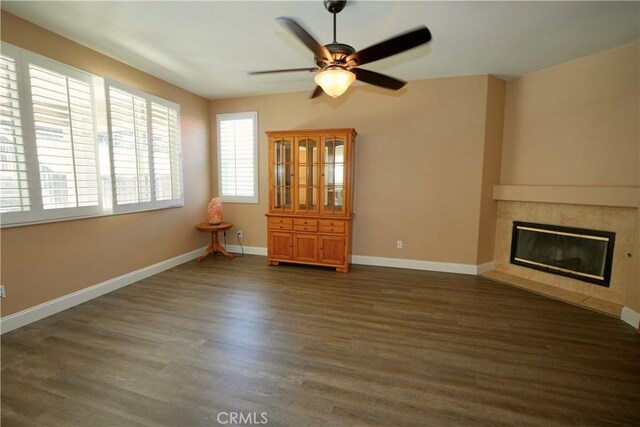 29429 Masters Dr, Murrieta, CA 92563 - unfurnished living room featuring a ceiling fan, a tile fireplace, wood finished floors, and baseboards