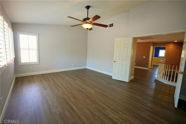29429 Masters Dr, Murrieta, CA 92563 - empty room with dark wood-type flooring, ceiling fan, baseboards, and high vaulted ceiling
