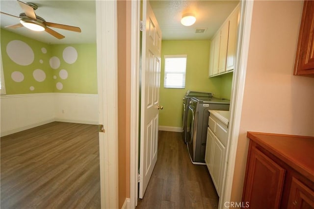 29429 Masters Dr, Murrieta, CA 92563 - washroom with cabinet space, washing machine and clothes dryer, ceiling fan, dark wood-style floors, and a wainscoted wall