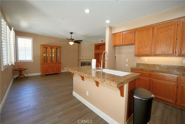 29429 Masters Dr, Murrieta, CA 92563 - kitchen with a sink, a glass covered fireplace, ceiling fan, dark wood-style flooring, and recessed lighting