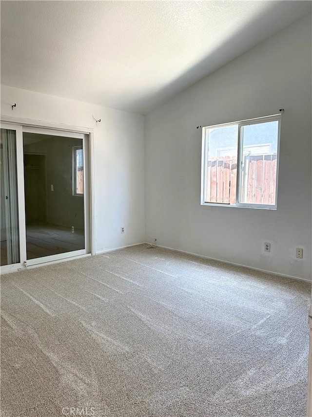 2582 Buchanan Ct, Perris, CA 92571 - spare room with carpet floors, healthy amount of natural light, vaulted ceiling, and baseboards