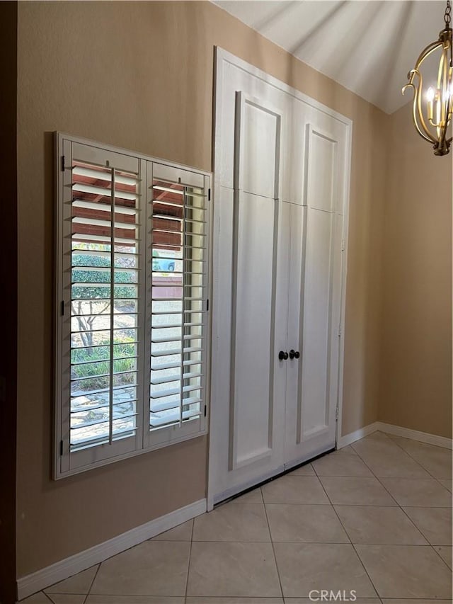 7950 Gardenia, Rancho Cucamonga, CA 91701 - unfurnished bedroom featuring a chandelier, baseboards, light tile patterned floors, and a closet