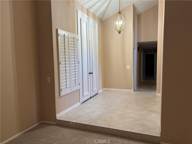 7950 Gardenia, Rancho Cucamonga, CA 91701 - entryway featuring a chandelier, baseboards, light tile patterned floors, and lofted ceiling