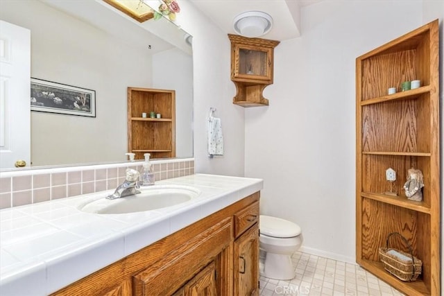 12355 Santa Ana Rd, Atascadero, CA 93422 - bathroom with toilet, vanity, tasteful backsplash, baseboards, and tile patterned floors