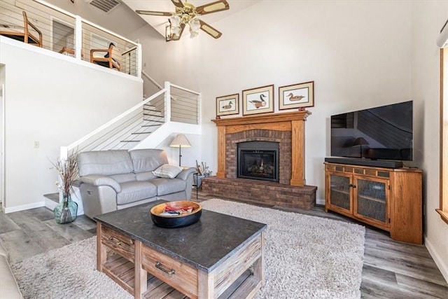 12355 Santa Ana Rd, Atascadero, CA 93422 - living room featuring wood finished floors, a ceiling fan, baseboards, stairway, and a towering ceiling
