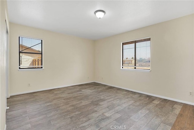 19002 Vine St, Hesperia, CA 92345 - empty room featuring healthy amount of natural light, wood finished floors, and baseboards