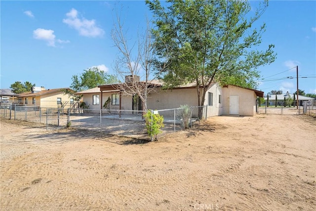 19002 Vine St, Hesperia, CA 92345 - rear view of property with stucco siding and a gate