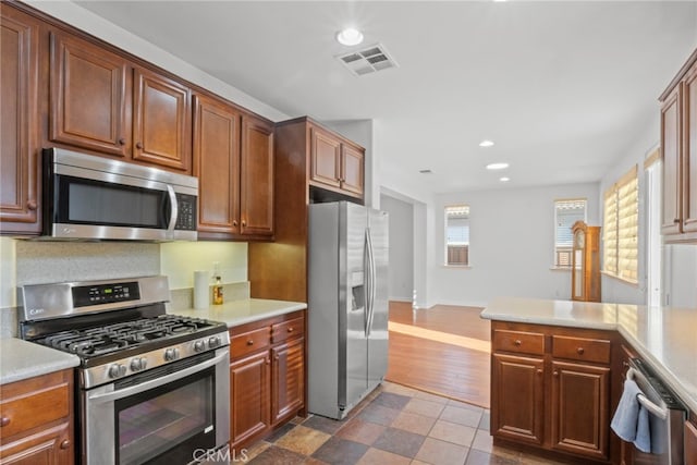 211 Furyk Way, Hemet, CA 92545 - kitchen featuring appliances with stainless steel finishes, recessed lighting, light countertops, and a peninsula