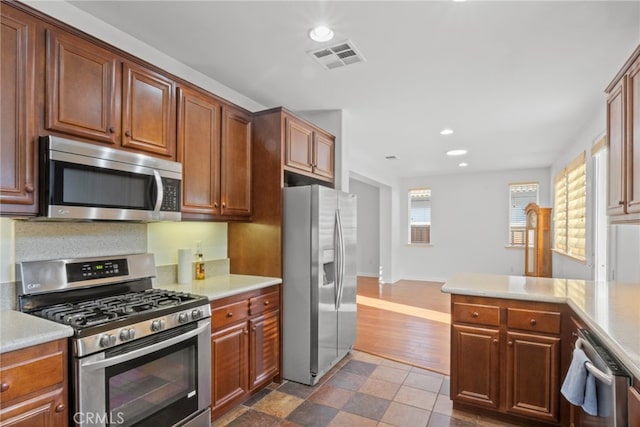 211 Furyk Way, Hemet, CA 92545 - kitchen with appliances with stainless steel finishes, recessed lighting, light countertops, and a peninsula