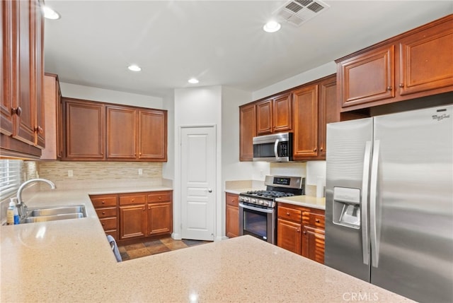211 Furyk Way, Hemet, CA 92545 - kitchen with appliances with stainless steel finishes, a sink, recessed lighting, decorative backsplash, and brown cabinetry