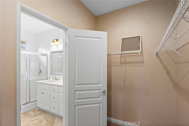211 Furyk Way, Hemet, CA 92545 - bathroom featuring a stall shower, a walk in closet, and vanity