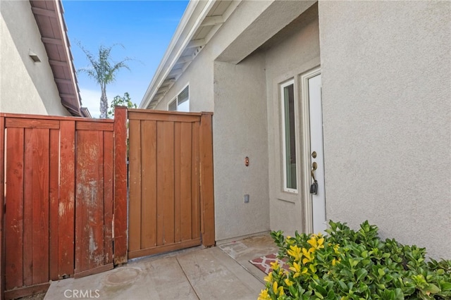 211 Furyk Way, Hemet, CA 92545 - doorway to property with stucco siding and a gate