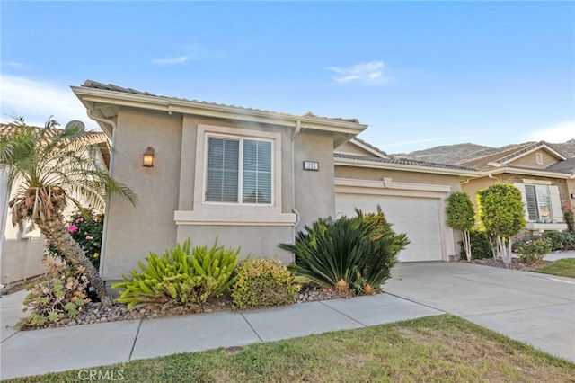 211 Furyk Way, Hemet, CA 92545 - view of front facade featuring an attached garage, stucco siding, and concrete driveway