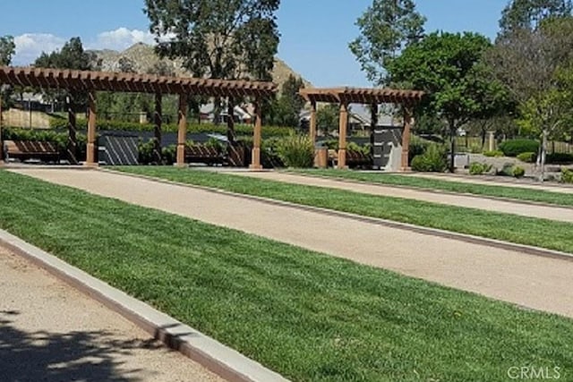 211 Furyk Way, Hemet, CA 92545 - surrounding community featuring a pergola, a game area, and a lawn