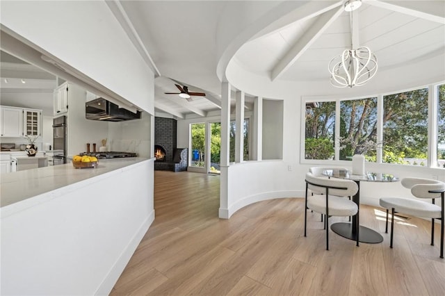 25870 Westwind Way, Los Altos Hills, CA 94022 - dining area with a brick fireplace, ceiling fan, a chandelier, light wood finished floors, and baseboards