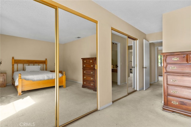 2380 Peppertree Ln, Riverside, CA 92506 - bedroom featuring multiple closets and light colored carpet