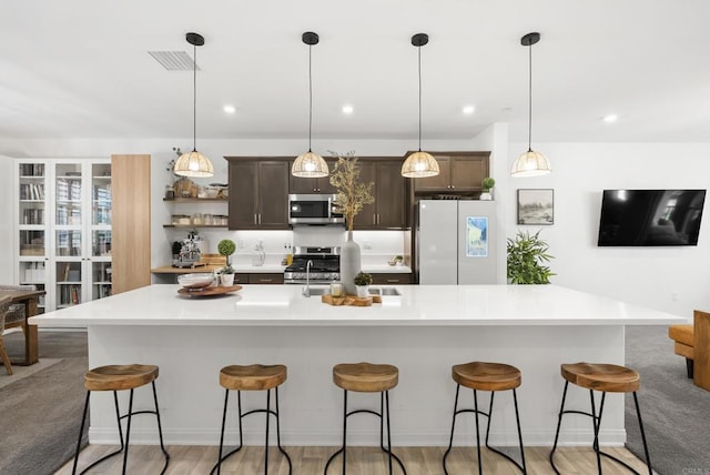 1836 Mesquite, Oceanside, CA 92056 - kitchen featuring stainless steel appliances, light countertops, dark brown cabinetry, a large island, and recessed lighting