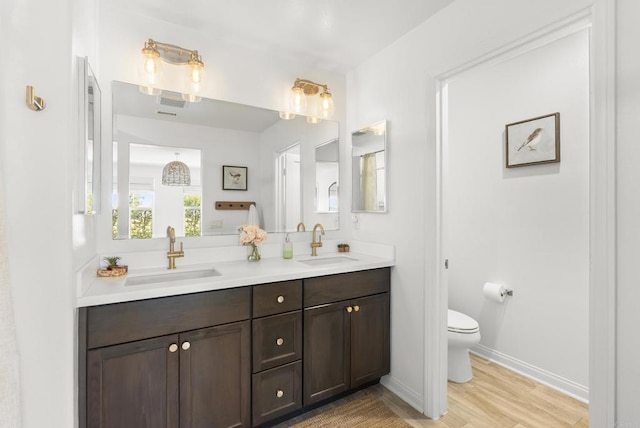 1836 Mesquite, Oceanside, CA 92056 - full bathroom featuring double vanity, toilet, wood finished floors, and baseboards
