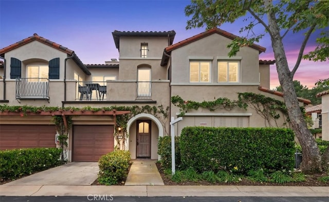 1 Sorrento Ct, Newport Coast, CA 92657 - mediterranean / spanish home with a balcony, driveway, stucco siding, an attached garage, and a tile roof