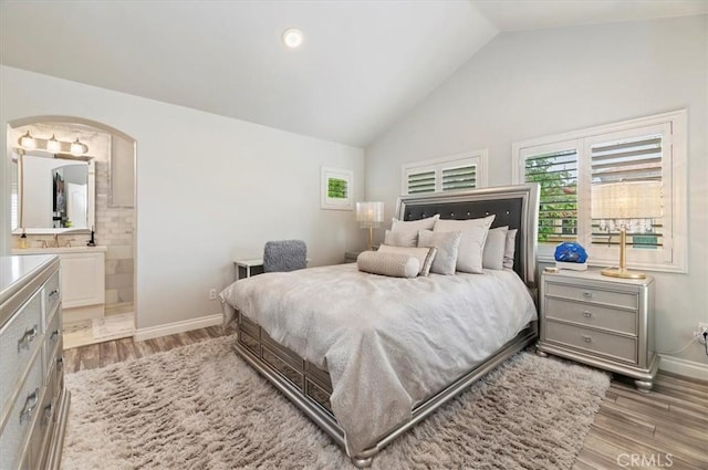 1 Sorrento Ct, Newport Coast, CA 92657 - bedroom featuring multiple windows, arched walkways, vaulted ceiling, and wood finished floors