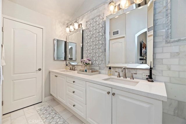 1 Sorrento Ct, Newport Coast, CA 92657 - bathroom with double vanity, marble finish flooring, lofted ceiling, and baseboards