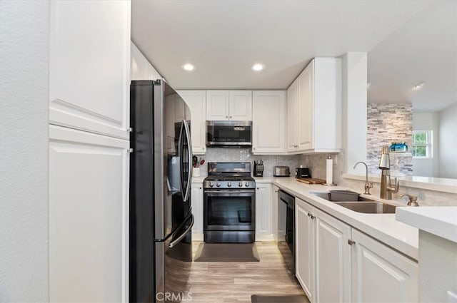 1 Sorrento Ct, Newport Coast, CA 92657 - kitchen featuring stainless steel appliances, a sink, white cabinets, backsplash, and light countertops