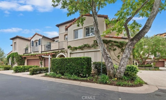 1 Sorrento Ct, Newport Coast, CA 92657 - mediterranean / spanish home featuring a balcony, a garage, stucco siding, concrete driveway, and a tiled roof