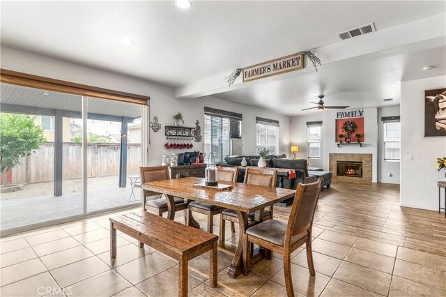3568 Rock Butte Pl, Perris, CA 92570 - dining room featuring healthy amount of natural light, light tile patterned floors, a ceiling fan, a tile fireplace, and recessed lighting