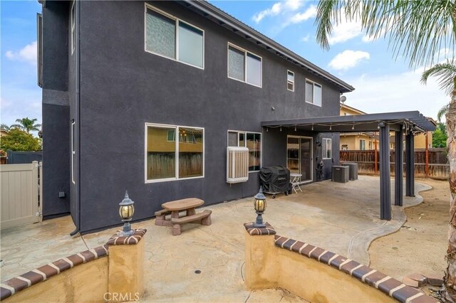 3568 Rock Butte Pl, Perris, CA 92570 - rear view of property with stucco siding, a patio area, and central air condition unit