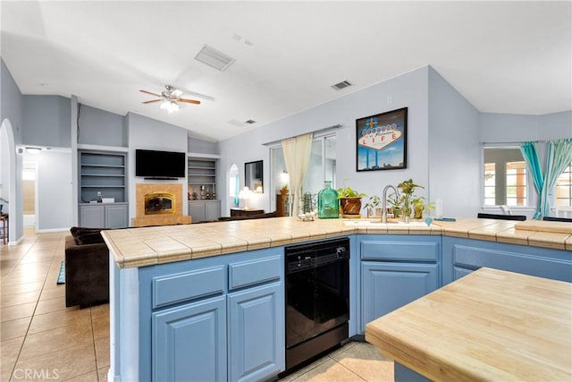 1679 Desert Front Rd, Wrightwood, CA 92397 - kitchen with black dishwasher, lofted ceiling, a ceiling fan, open floor plan, and light tile patterned flooring