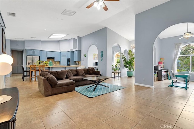 1679 Desert Front Rd, Wrightwood, CA 92397 - living area featuring ceiling fan, arched walkways, light tile patterned flooring, baseboards, and a towering ceiling