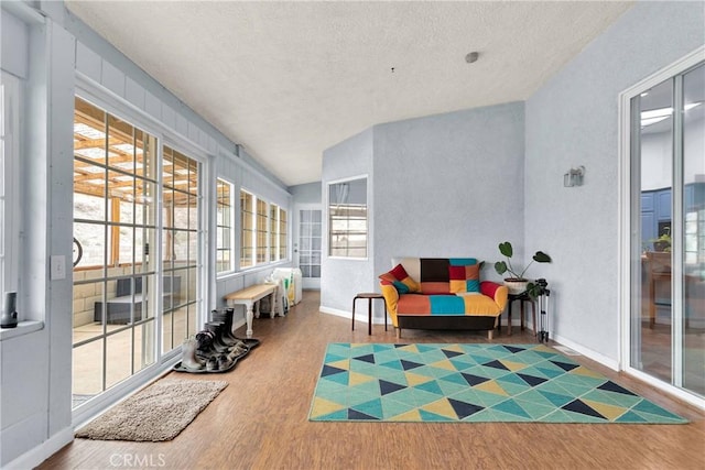1679 Desert Front Rd, Wrightwood, CA 92397 - sunroom featuring wood finished floors, a textured ceiling, vaulted ceiling, and baseboards