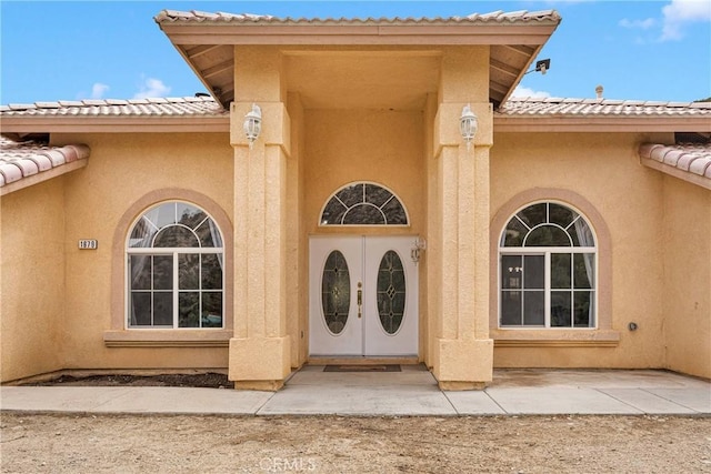 1679 Desert Front Rd, Wrightwood, CA 92397 - view of exterior entry with stucco siding and a tile roof