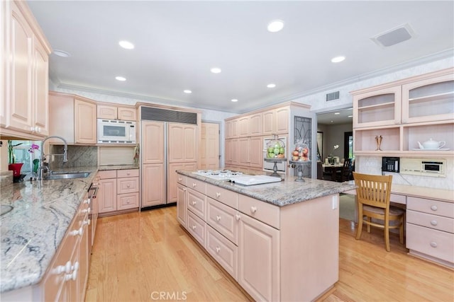 19043 Citronia St, Northridge, CA 91324 - kitchen with built in appliances, ornamental molding, a kitchen island, light wood-type flooring, and backsplash