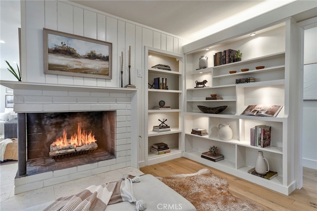 1035 Medford Rd, Pasadena, CA 91107 - sitting room with a fireplace, wood finished floors, and built in shelves