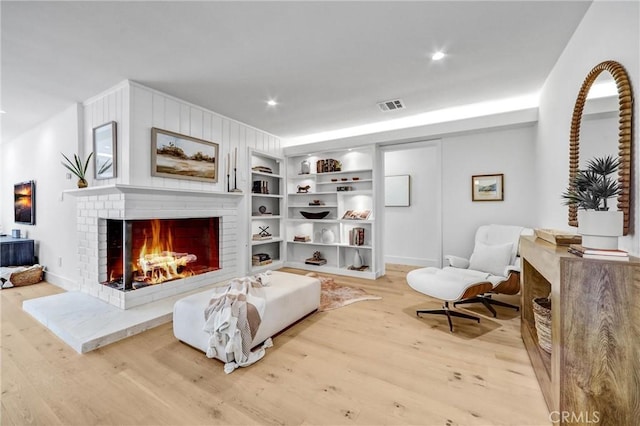 1035 Medford Rd, Pasadena, CA 91107 - living area with light wood finished floors, a fireplace, built in features, and recessed lighting
