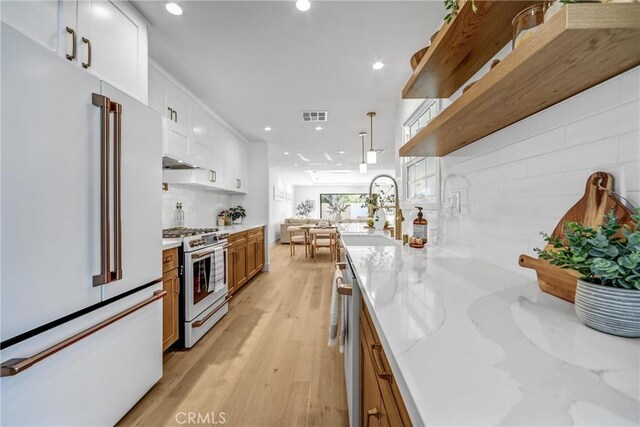 1035 Medford Rd, Pasadena, CA 91107 - kitchen with stainless steel appliances, tasteful backsplash, recessed lighting, light wood-type flooring, and white cabinetry