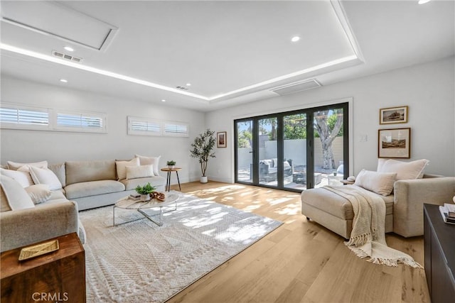 1035 Medford Rd, Pasadena, CA 91107 - living room featuring light wood-style flooring, a tray ceiling, attic access, and recessed lighting