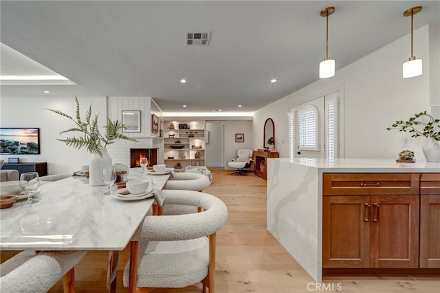 1035 Medford Rd, Pasadena, CA 91107 - dining area with recessed lighting, light wood finished floors, and a fireplace