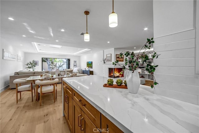 1035 Medford Rd, Pasadena, CA 91107 - kitchen with brown cabinets, light wood finished floors, open floor plan, a fireplace, and recessed lighting