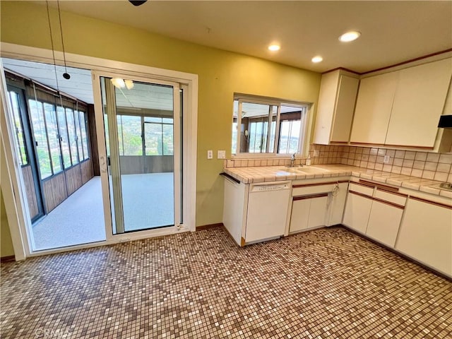 33042 Palo Alto St, Dana Point, CA 92629 - kitchen featuring dishwasher, tile counters, a sink, backsplash, and white cabinetry