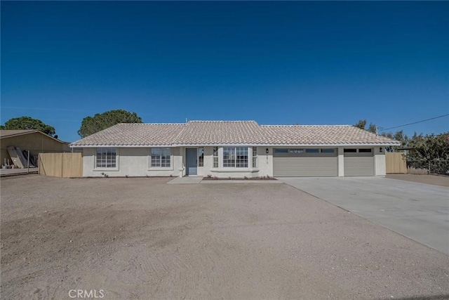 9810 Pyrite Ave, Hesperia, CA 92345 - single story home featuring an attached garage, a tiled roof, driveway, and stucco siding