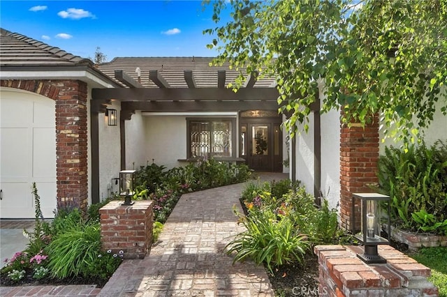 26065 Charing Cross Rd, Valencia, CA 91355 - entrance to property featuring stucco siding, a pergola, and a tiled roof